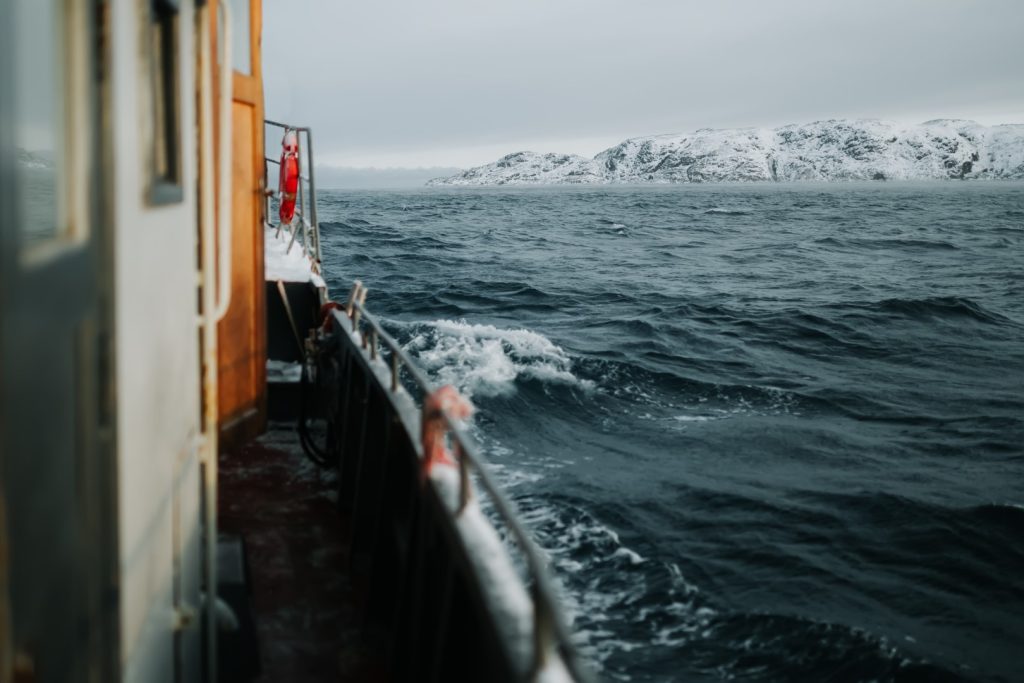 fishing ship is swimming at sea at winter
